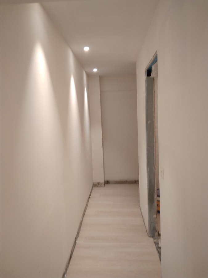 Pasillo con focos al lateral.