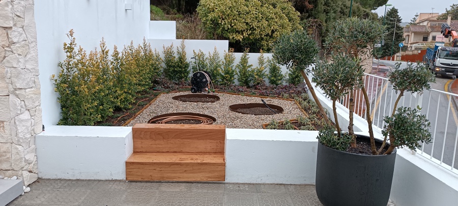 Jardín con grava y zonas de huerto.