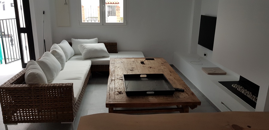 Salón con chimenea y cocina abierta