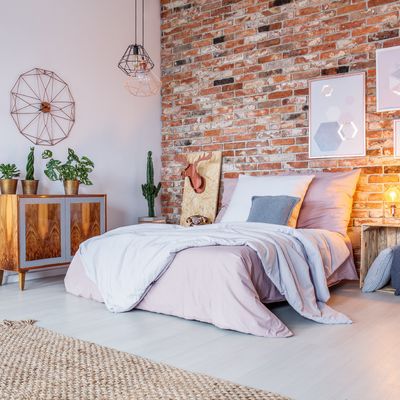 Dormitorio rústico con papel pintado en el cabecero