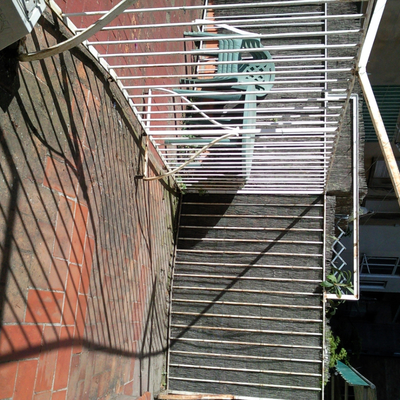 Rehabilitación de terrazas en pisos primero, fachada posterior de edificio plurifamiliar.